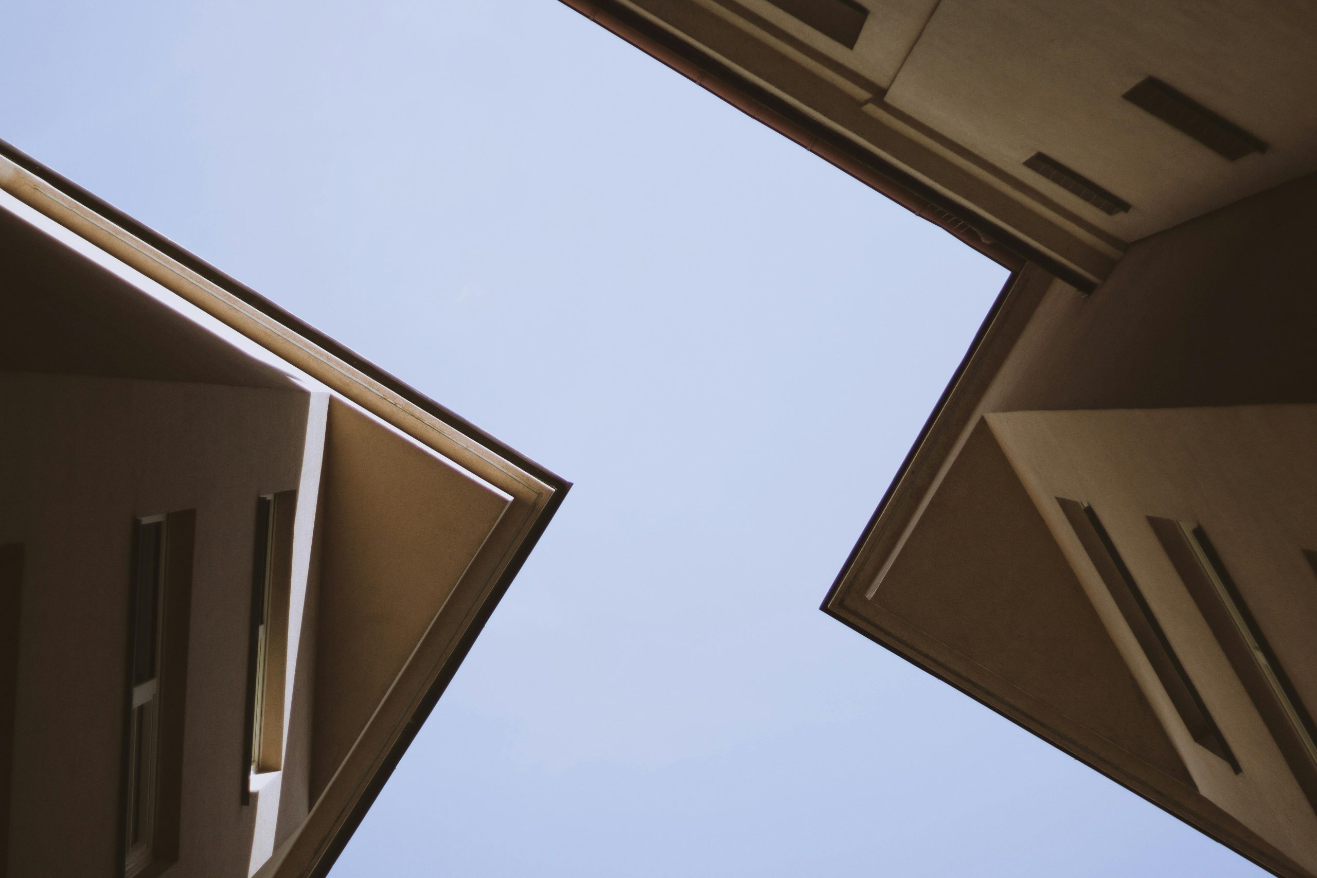 Abstract view of modern buildings in Vienna showcasing geometric design against a clear sky.